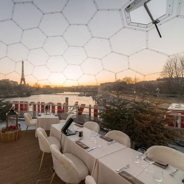 11 metre outdoor dining dome with the Eiffel Tower in the background and the Seine river flowing below