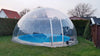 Outdoor Perspex dome covering a circular swimming pool in a garden
