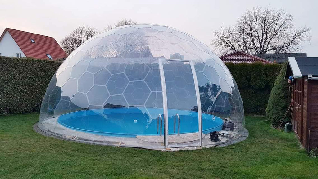 Outdoor Perspex dome covering a circular swimming pool in a garden