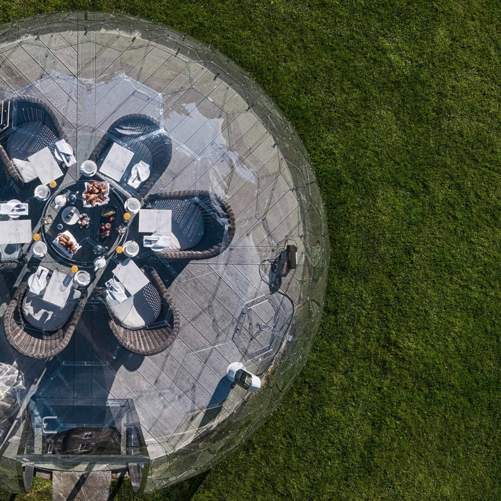 Outdoor dining dome as seen from above surrounded by grass