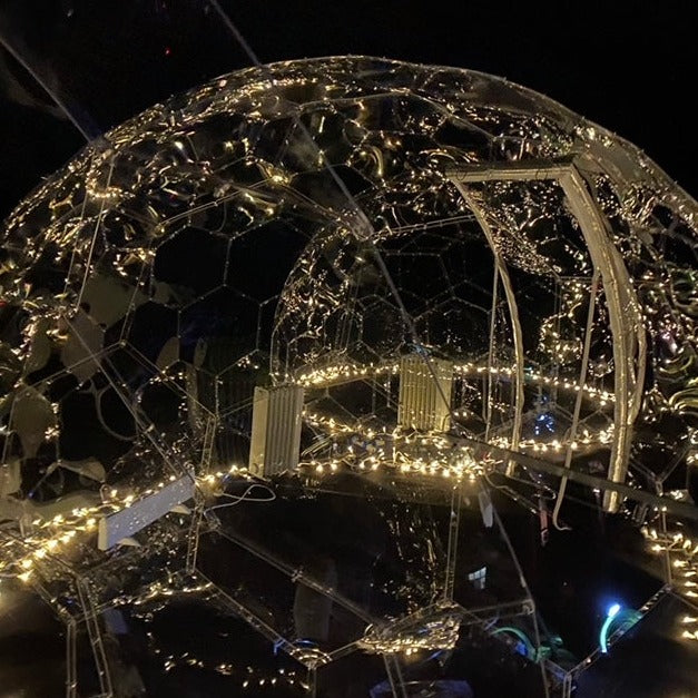 Fairy lights transform an Aura Dome at night