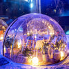 3.6m outdoor dining dome surrounded by snow with glue lights and table set for 6 to dine in