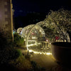 Multiple Aura Domes outside a hotel lit with fairy lights