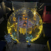 An Aura Dome lit up with fairy lights ready for a dinner party in the garden