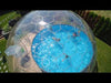 video of people enjoying swimming in a pool covered with a large outdoor perspex dome. Dome includes ventilation window